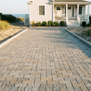Freshly installed paver driveway with Belgian block edging at a coastal New Jersey residential property hardscaping project