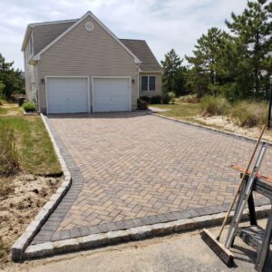 Paver driveway installation with Belgian block edging in lower Cape May County