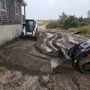 Yard grading with skid steers reshaping a coastal lot in lower Cape May County